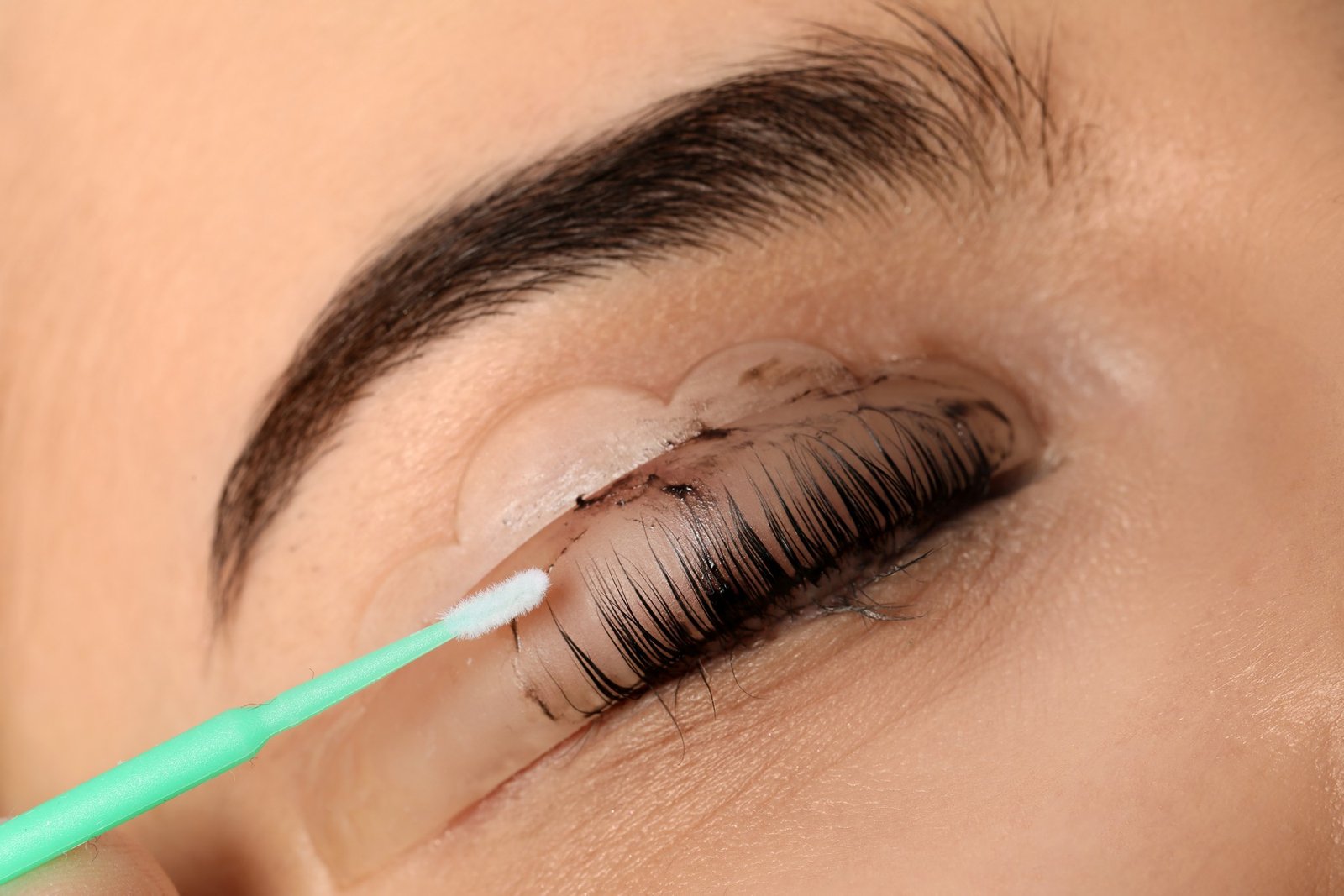 Wimpernkleber und Klebereste werden entfernt